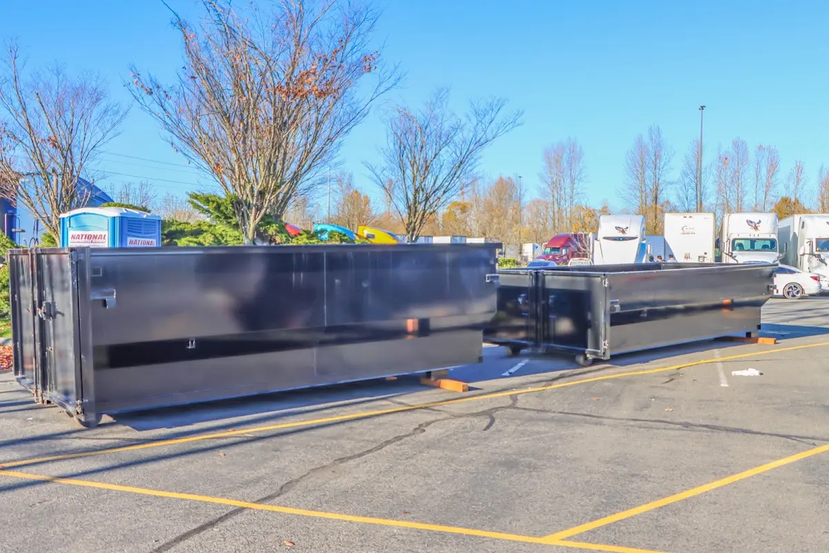 Professional dumpster rental service with roll-off container on residential driveway in Schuylkill